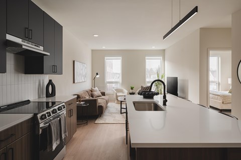 A modern kitchen with dark wood cabinets and a white countertop.