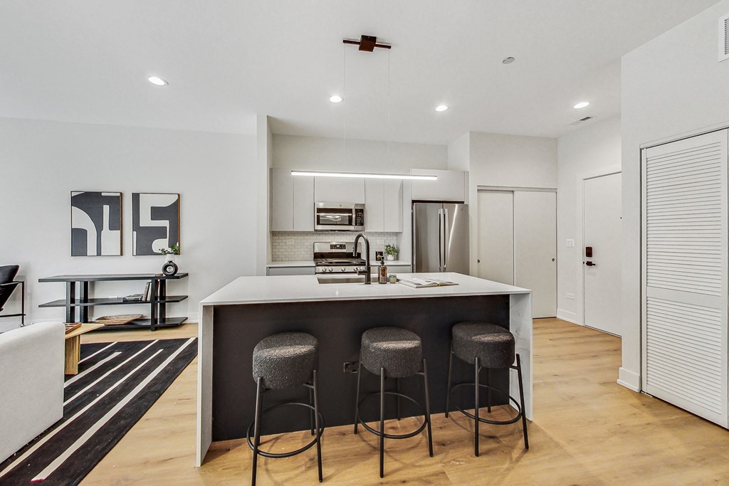 A modern kitchen with a bar stool.