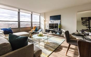 a living room with a large window and a couch and a table