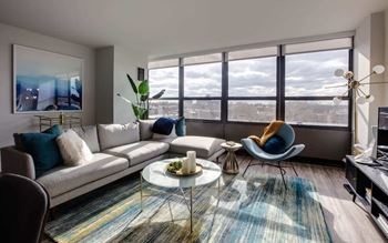 a living room with a large window and a couch and a coffee table