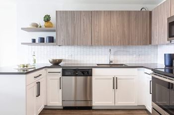 a kitchen with white cabinets and stainless steel appliances
