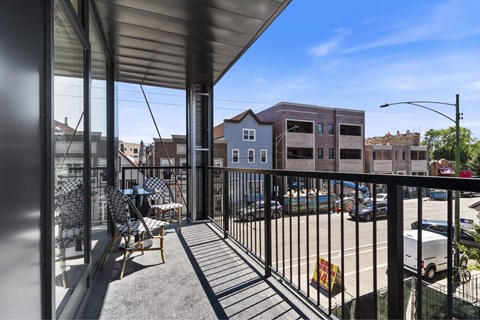 a balcony with a view of a parking lot and buildings