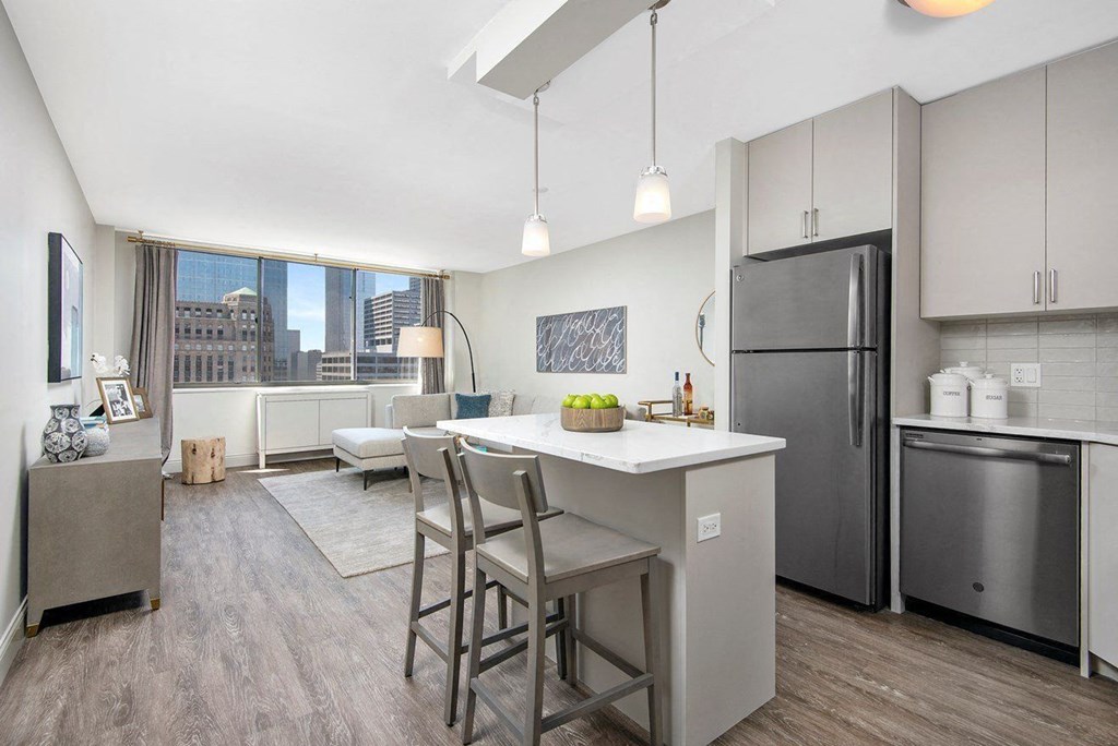 A modern kitchen with a dining table and chairs.