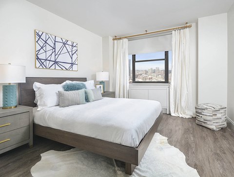 Bedroom with city view and modern furnishings at River North Park Apartments, Chicago