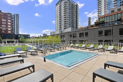 Rooftop pool deck with lounge chairs and city views at River North Park Apartments, Chicago, IL