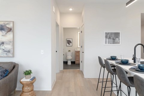 A modern dining area with a table set for two.