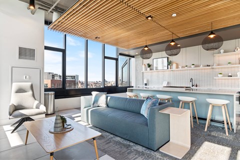 A modern living room with a blue couch and a wooden coffee table.