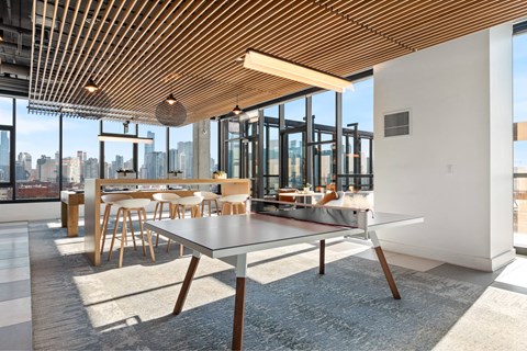 A modern dining area with a long table and chairs.
