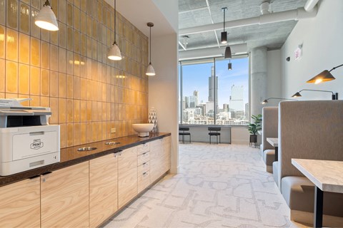 A modern office space with wooden cabinets and a city view through the window.