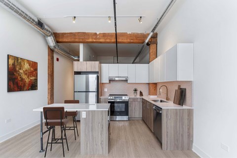 A modern kitchen with a dining table and chairs.