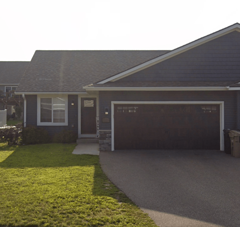 A house with a garage door that is closed.