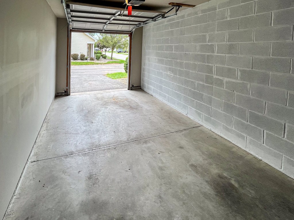 Interior of 1-car garage looking out towards driveway