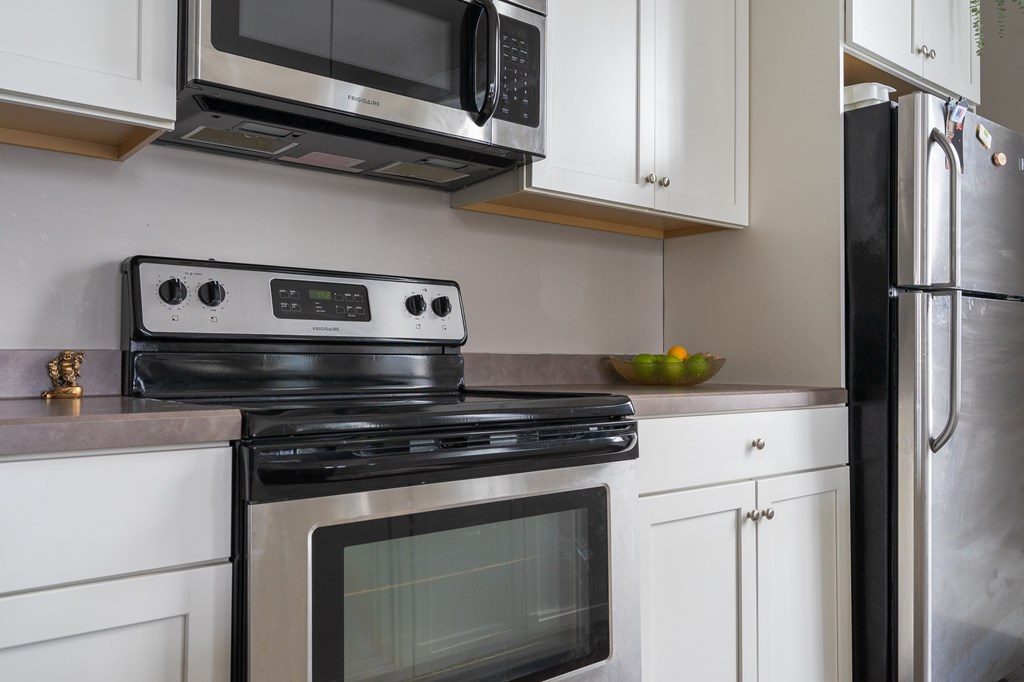Typical kitchen with stainless steel appliances (microwave, stove, refrigerator, dishwasher & disposal) (actual counters will be white quartz) Typical kitchen with stainless steel appliances (microwave, stove, refrigerator, dishwasher & disposal) (actual counters will be white quartz)