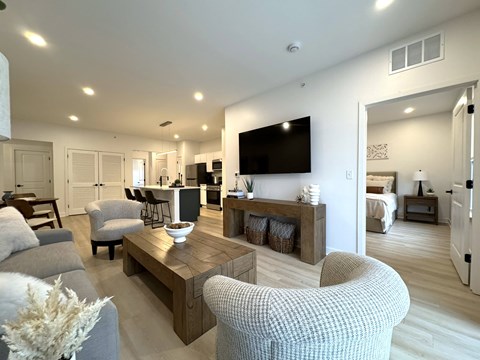 A modern living room with a grey sofa and a wooden coffee table.
