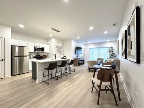 A modern kitchen with a dining table and chairs.