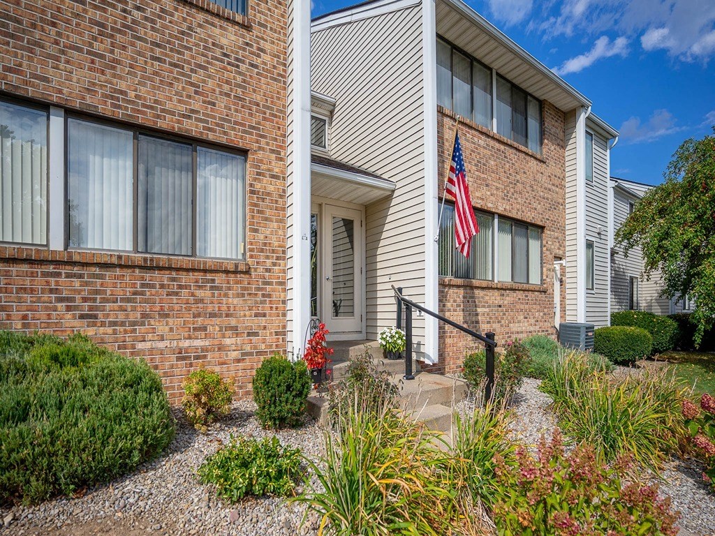 an apartment building with an flag in front of it