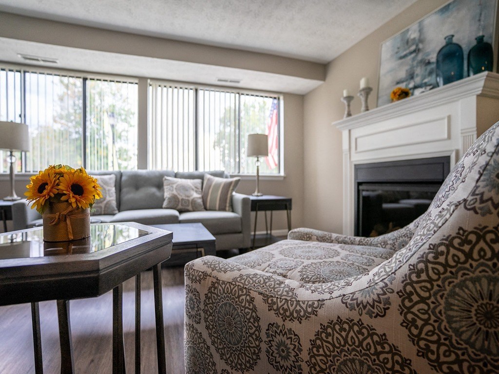 a living room with a couch and a table and a fireplace