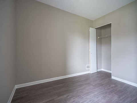 View of typical second bedroom with closet and faux plank flooring