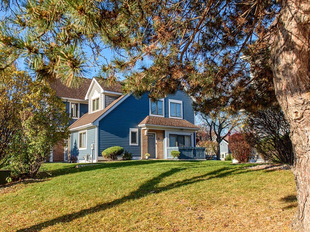 a blue house with a tree in front of it