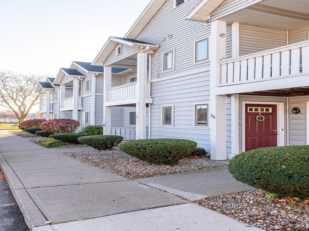 a row of white houses with a red door