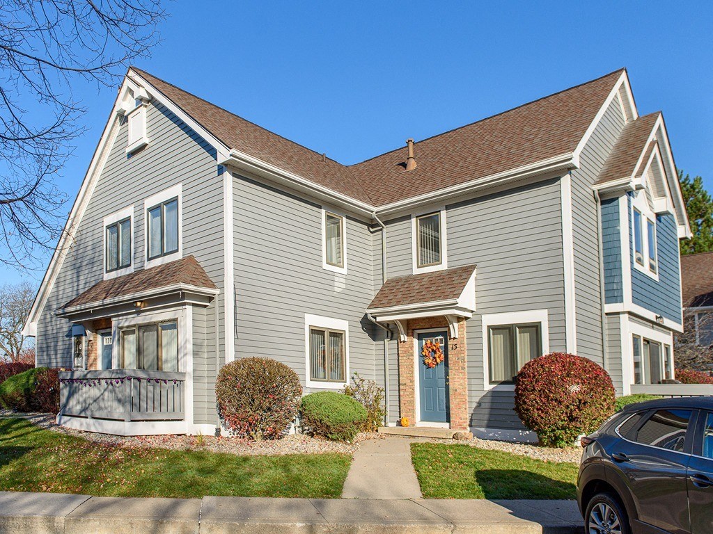 a blue house with a car parked in front of it