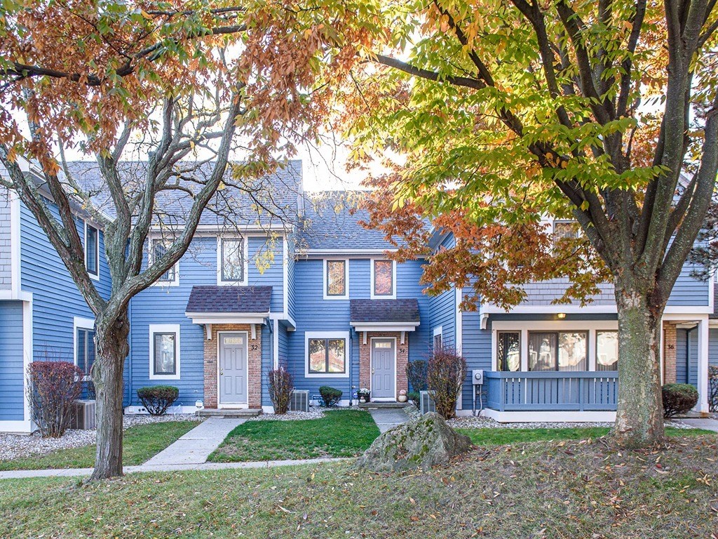 a blue house with trees in front of it