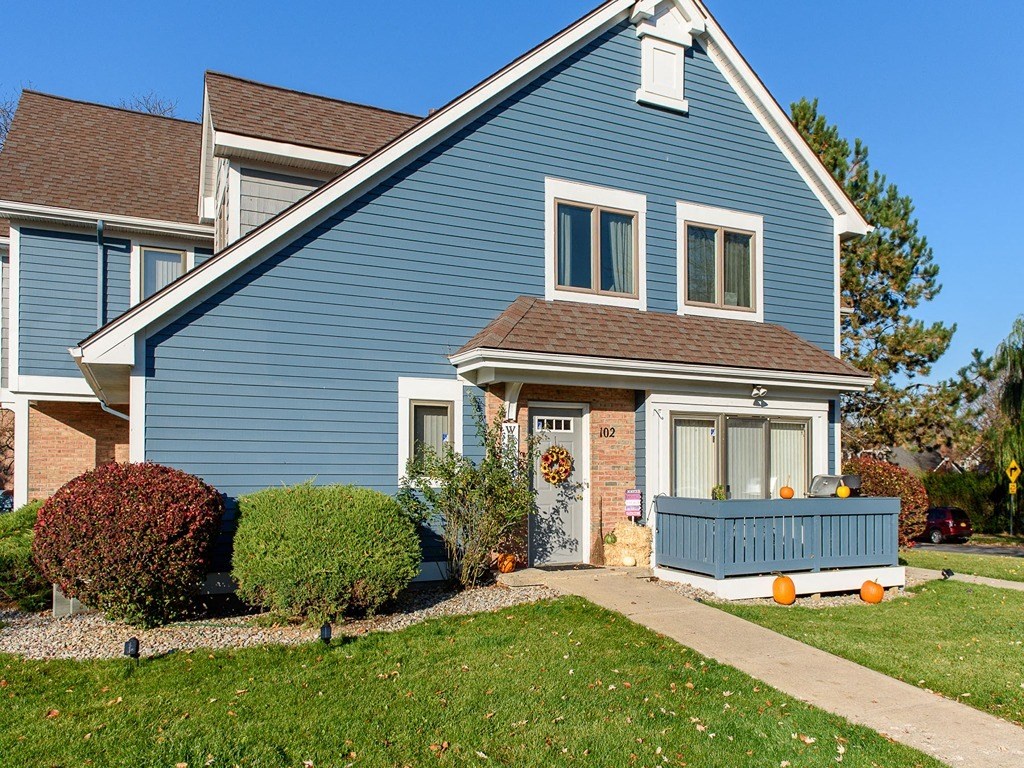 a blue house with a blue deck in front of it