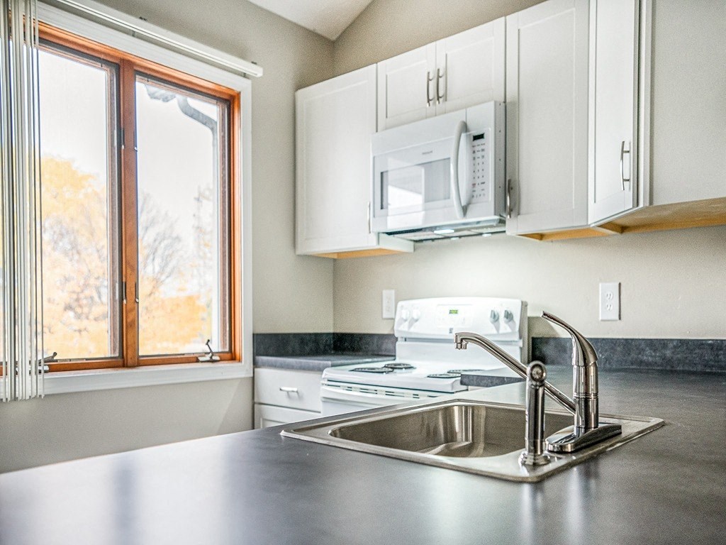 a kitchen with a sink and a window