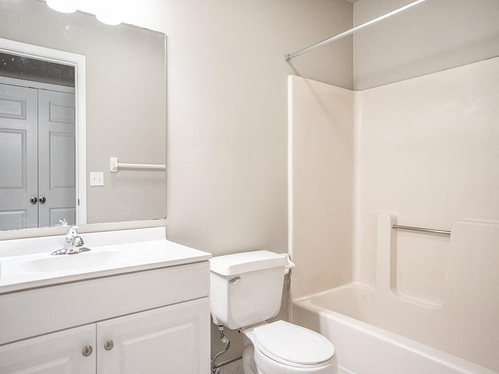 a bathroom with a sink toilet and a mirror