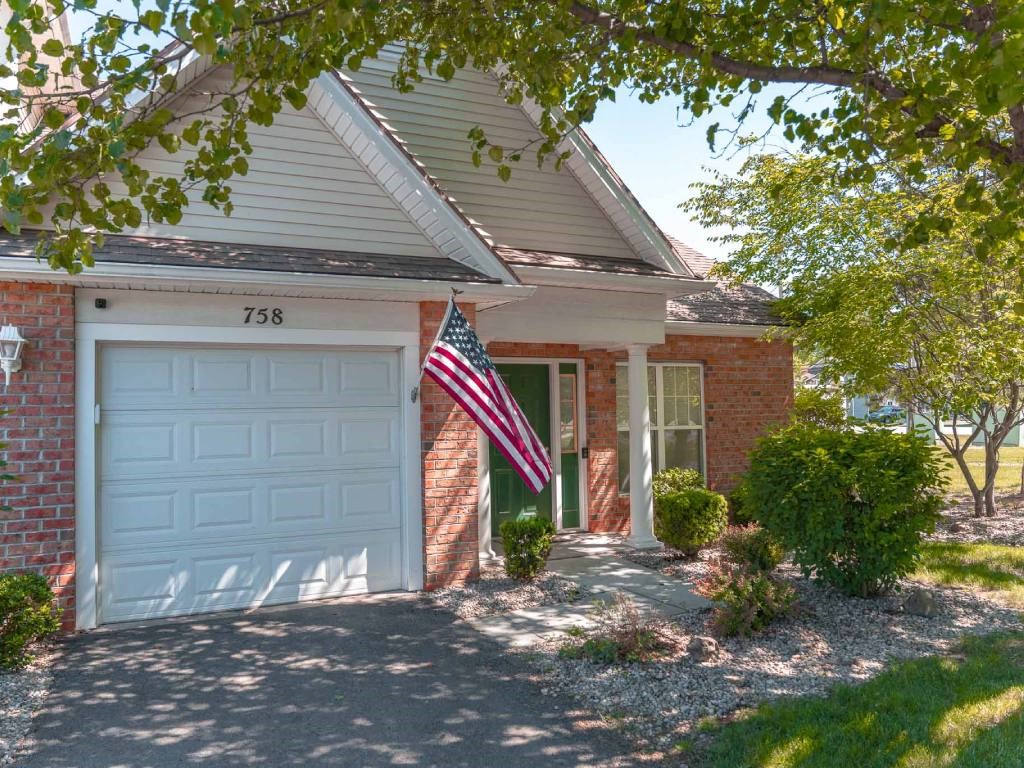 Exterior view of ranch end unit private entrance & attached 1-car garage