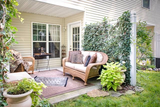 Exterior view of private patio with comfortable seating & decorative plants