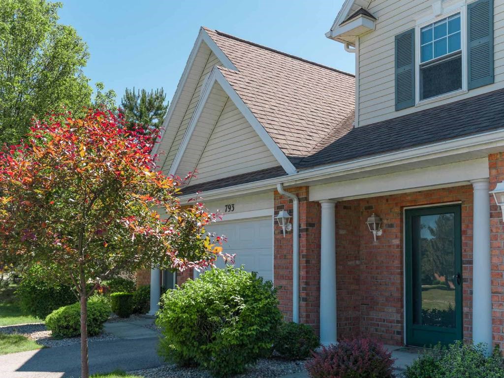 Exterior view of covered private entrance porch and attached 1-car garage at Webster Woods