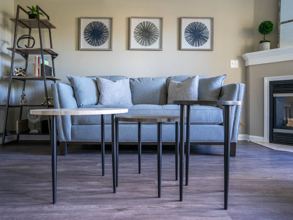View of living area of great room showing corner fireplace & plank flooring