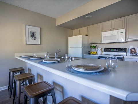a kitchen with a counter with plates on it