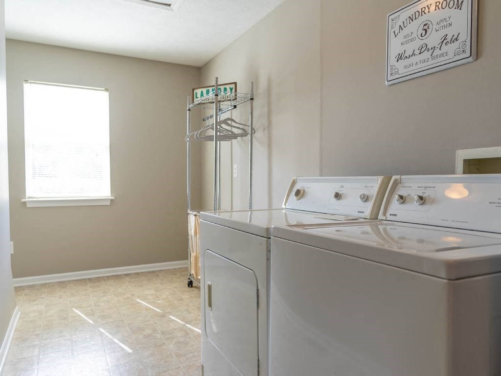 Interior view of large laundry room with full size washer & dryer