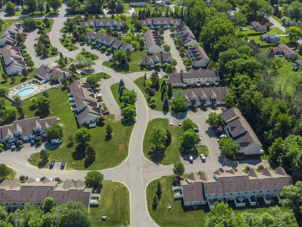 Exterior aerial view of Webster Woods townhomes neighborhood looking east towards 5-Mile Line Road