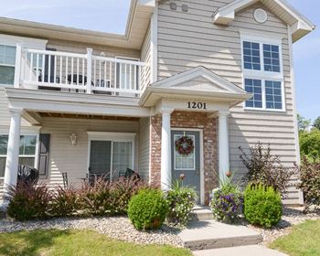 a white house with a porch and a yard