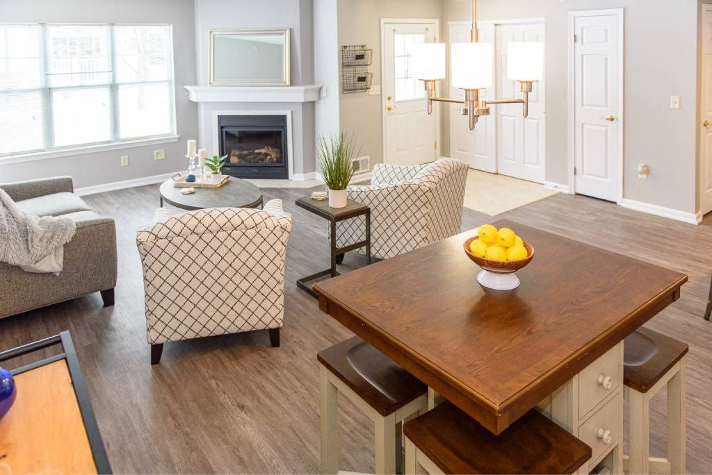 a living room with a table with a bowl of fruit on it
