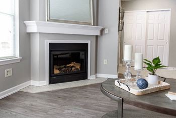 a living room with a fireplace and a table