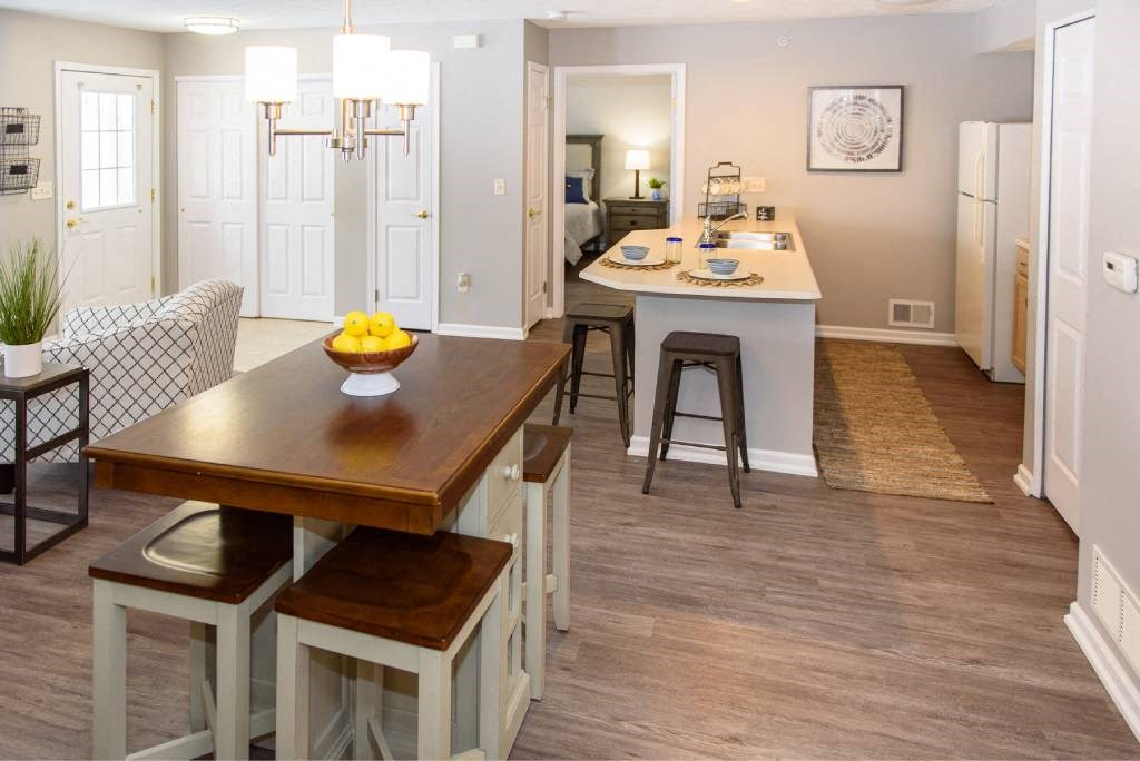 a kitchen and dining room with a table and chairs