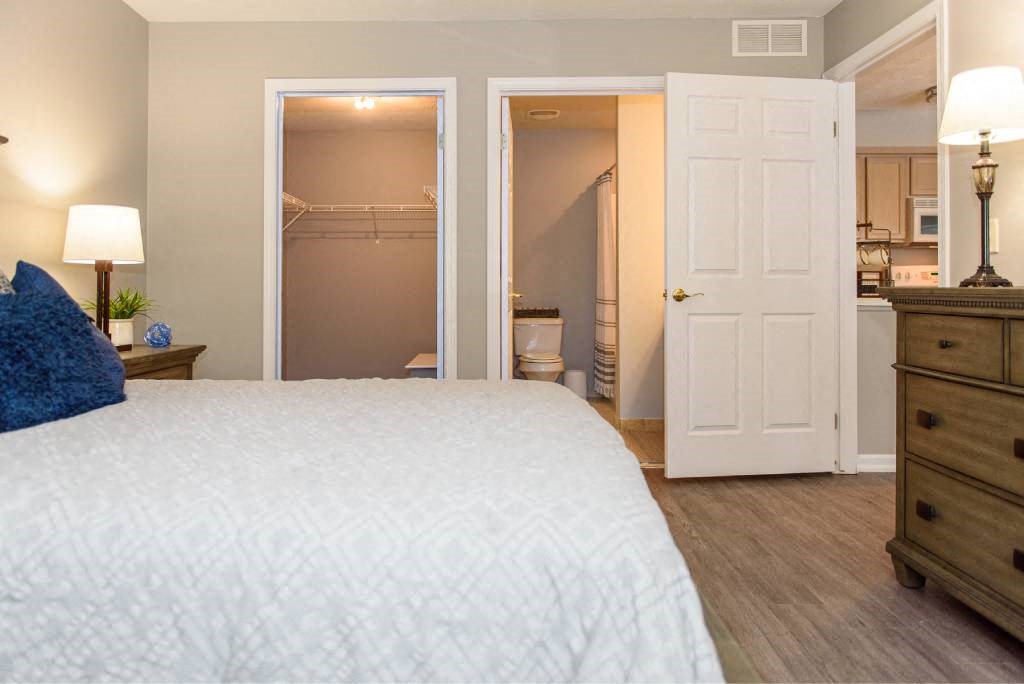 a bedroom with a white bed and a closet