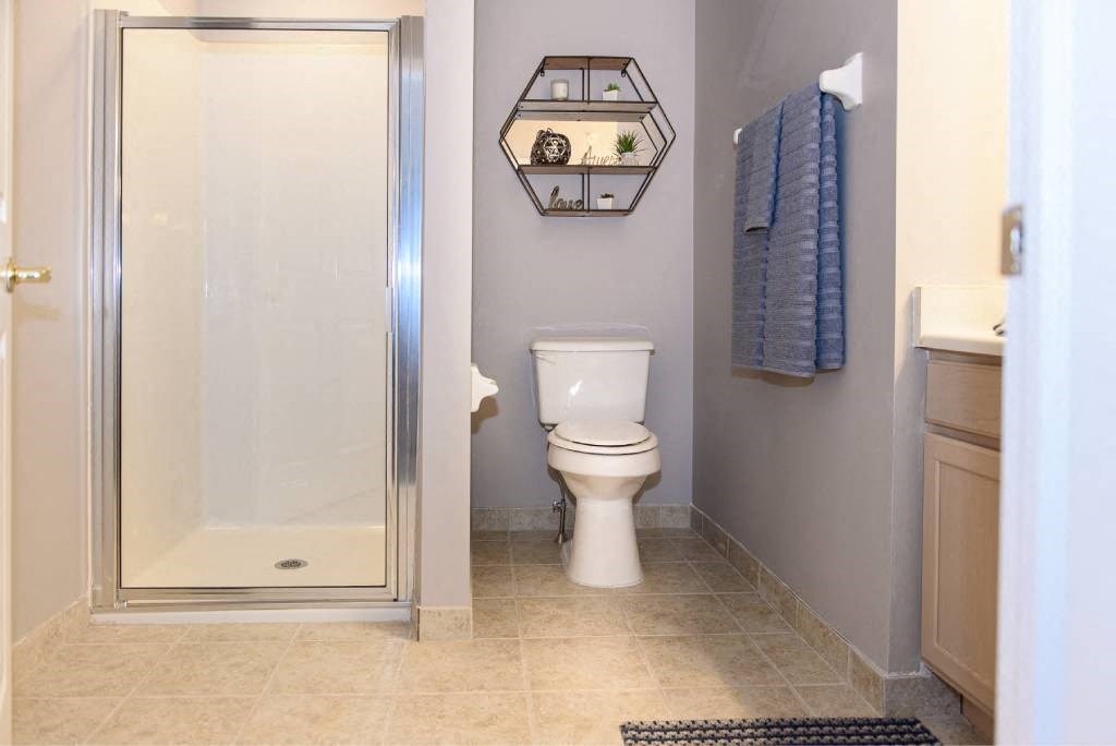 a bathroom with a toilet and a shower