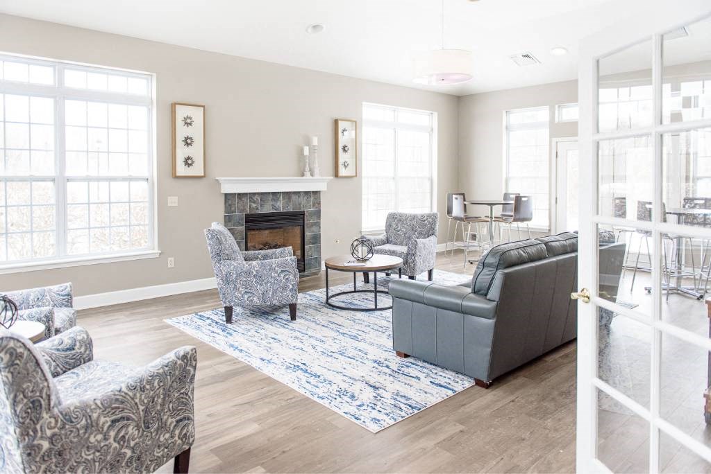 a living room with couches and chairs and a fireplace