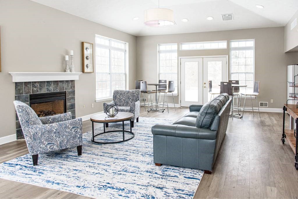 a living room with a couch and chairs and a fireplace