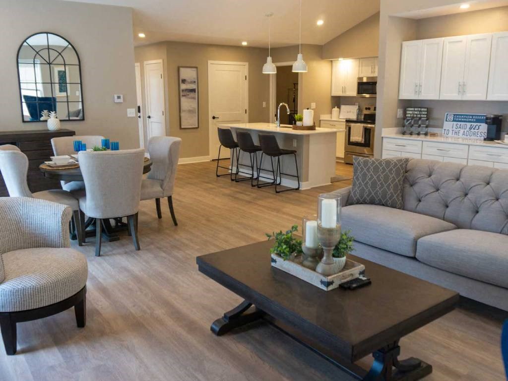 Interior of Champion Reserve Townhome Great Room showing living area, dining area, coffee bar, and kitchen area with breakfast bar.
