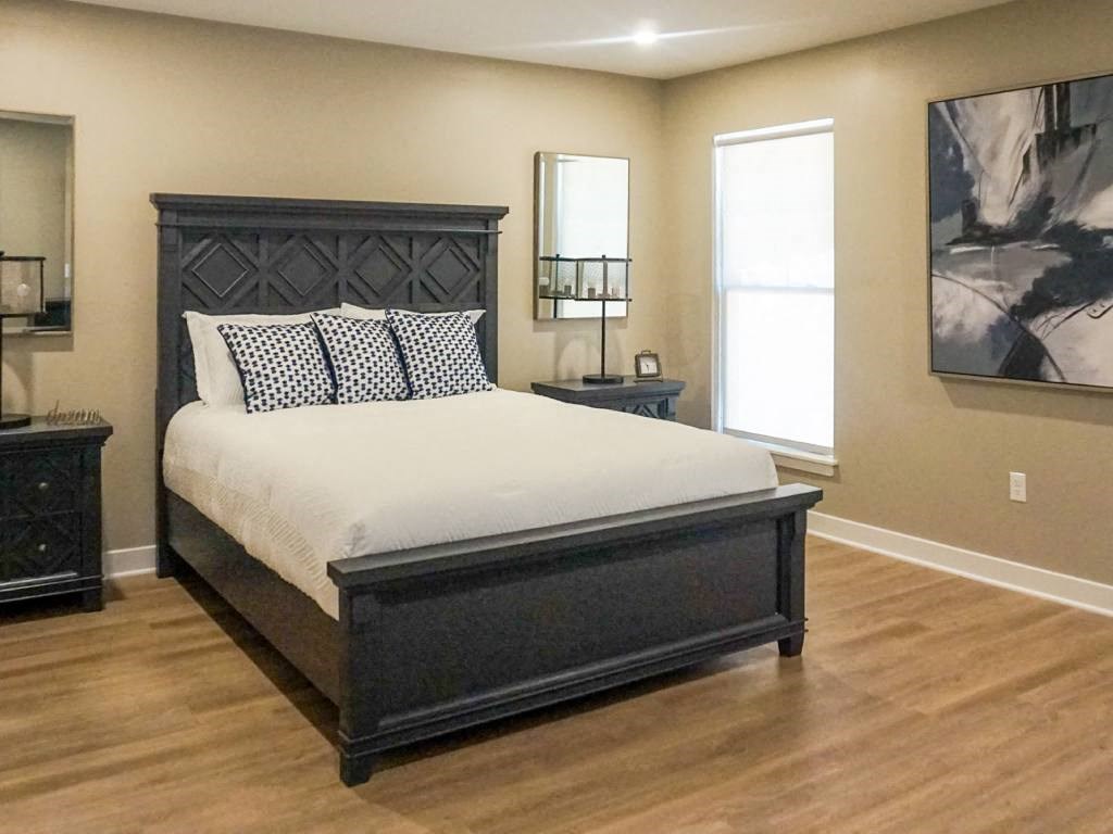 Interior of Champion Reserve Townhome primary bedroom with faux wood flooring.