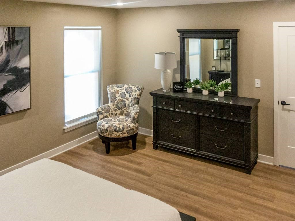Interior of Champion Reserve Townhome primary bedroom with faux wood flooring.