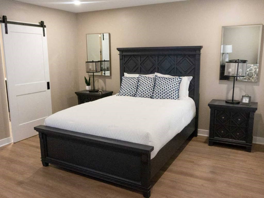 Interior of Champion Reserve Townhomes primary bedroom  with doorway to ensuite bathroom and walk-in closet closed.