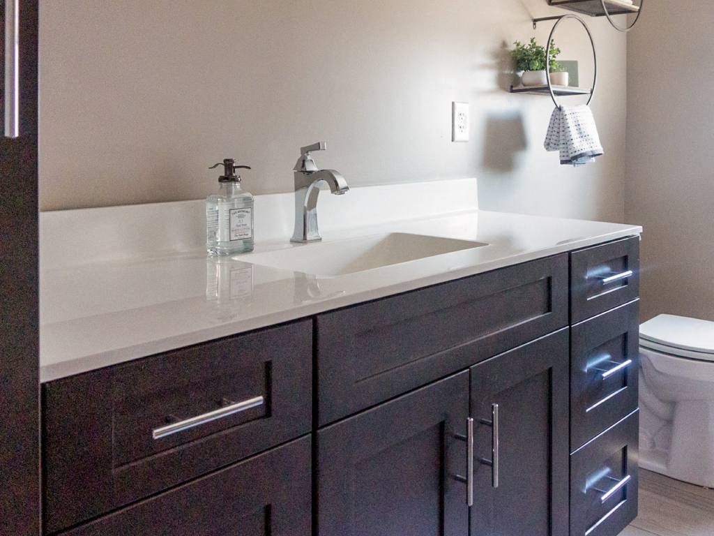 Interior of Champion Reserve Townhomes typical second bathroom with generous-size vanity and shower/tub combination.