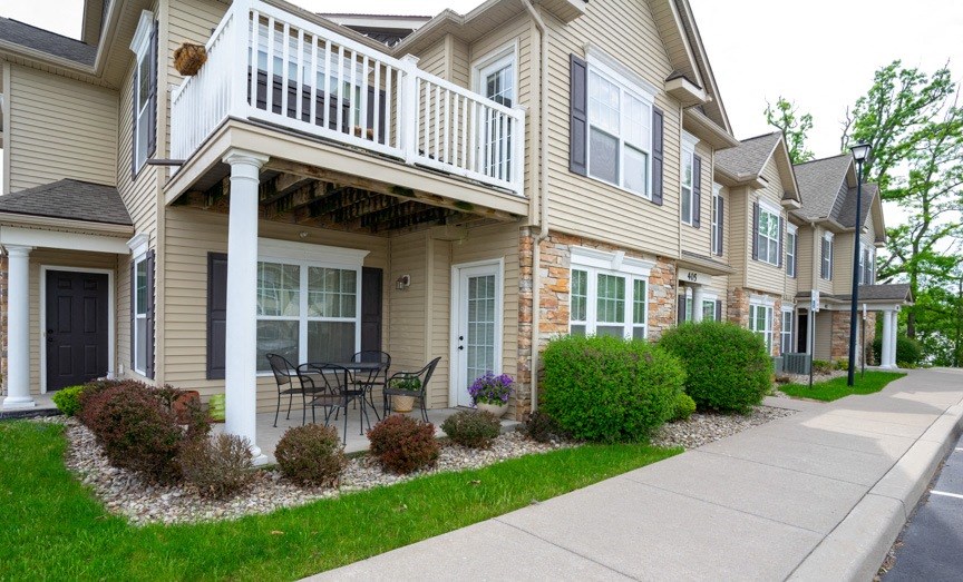 View of private patio and private balcony and sidewalk